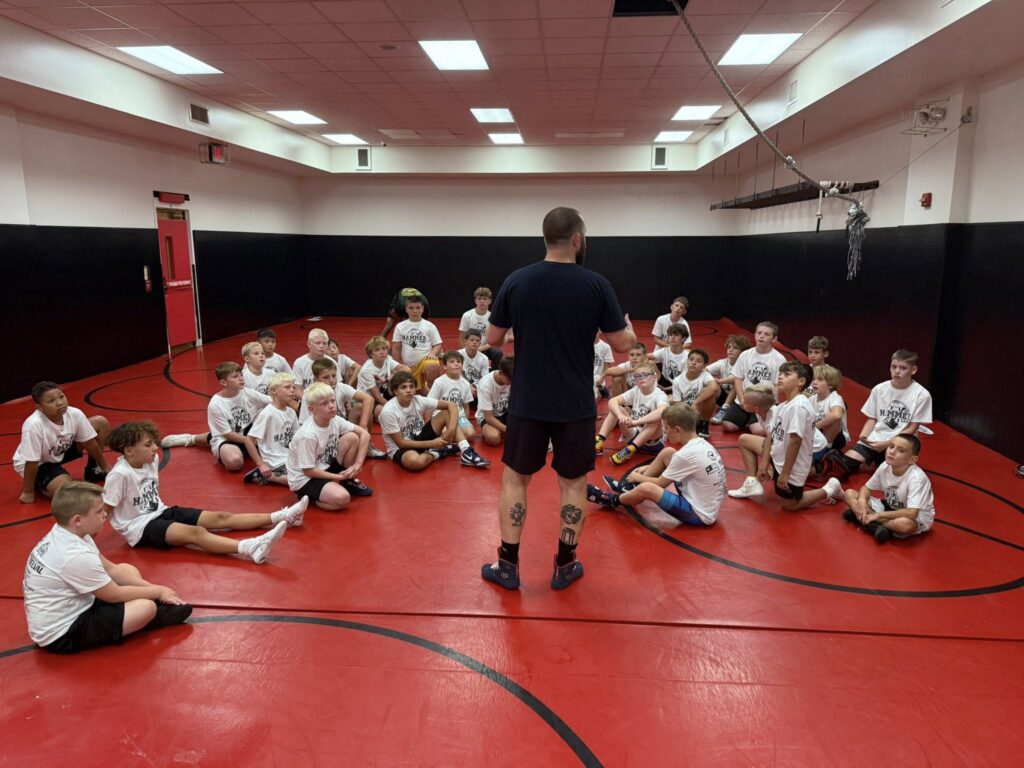 Chestnut Hill Wrestling Club Students listening to Coach Josh Dziewa discuss Wrestling Techniques